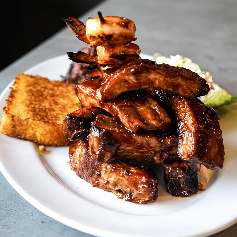 Galloway Diner and Grill's BBQ ribs and shrimp skewer, with a side of golden-brown toast and coleslaw.